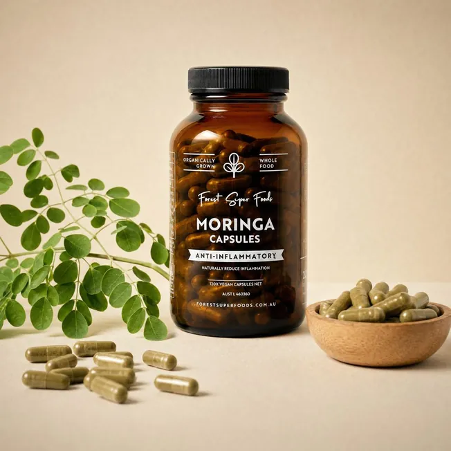 Forest Super Foods Organic Moringa Capsules jar with loose capsules and a fresh moringa sprig