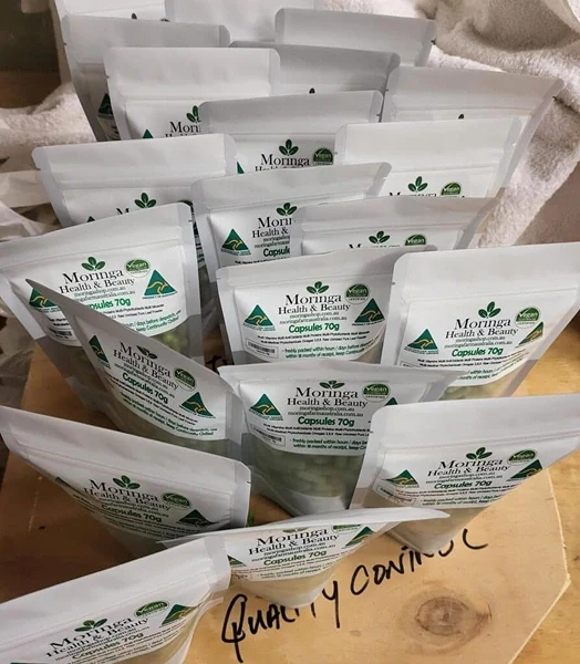 Multiple Australian Moringa Shop encapsulated moringa packs showing the product packaging and capsules.
